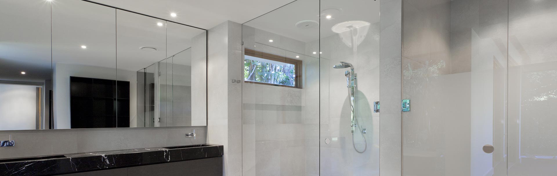 Bathroom showing a semi framed shower screen